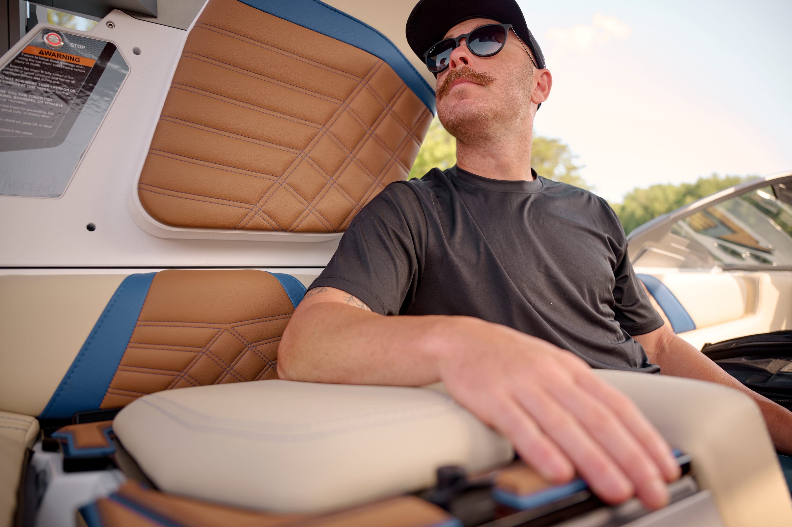 A man sits in the driver's seat of a Malibu 20 VTX