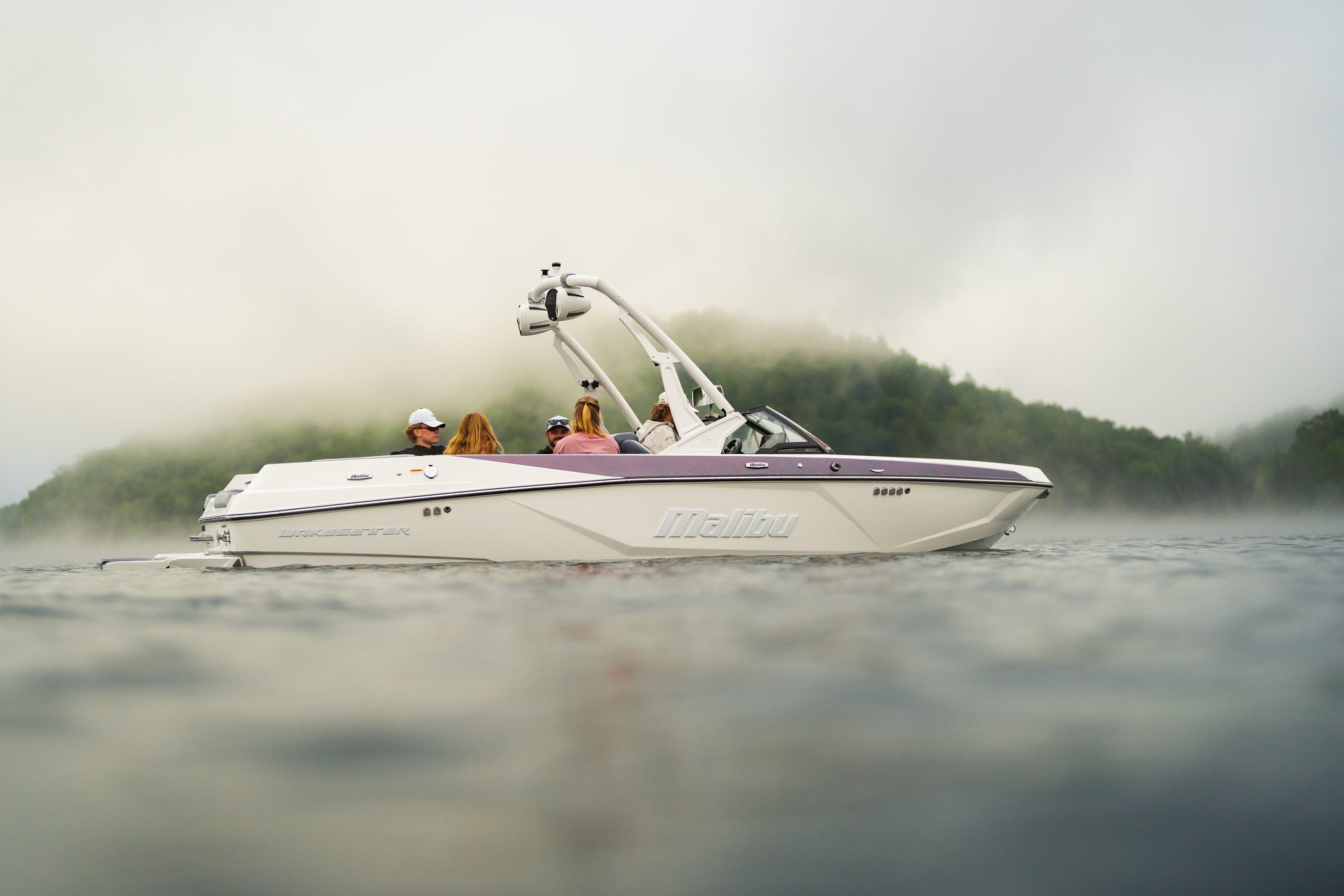 A Malibu 20 VTX at rest in morning mist, people aboard