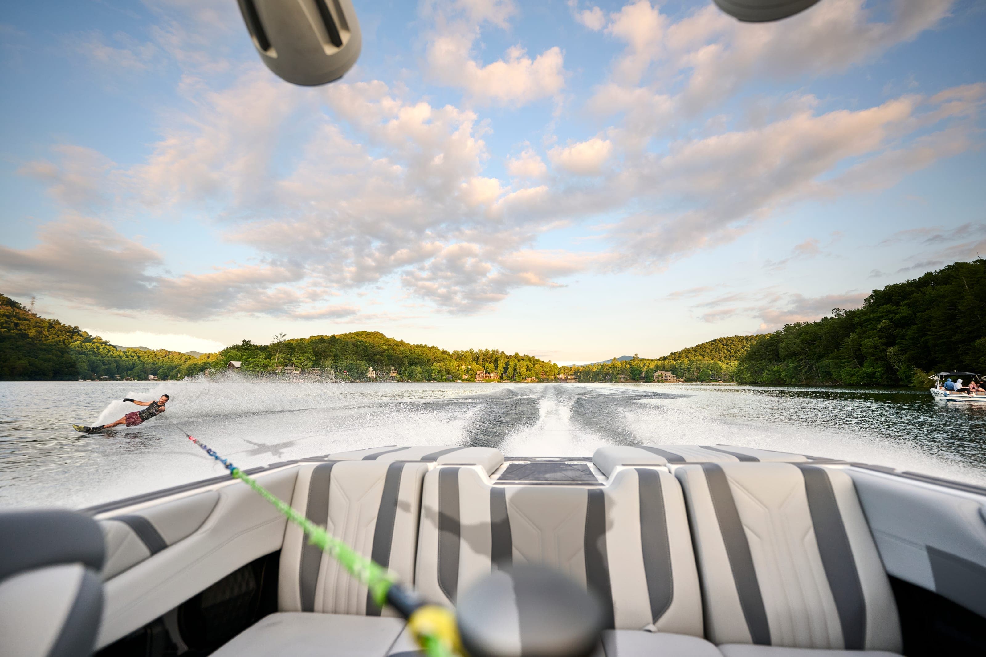 A waterskier behind a Malibu 20 VTX, seen from the boat along the tow rope