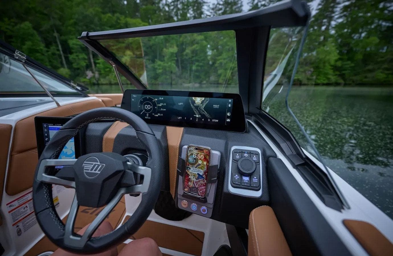 The helm and screens of a Malibu 21 LX