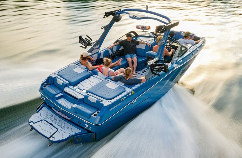 A Malibu 22 MXZ from above at speed in golden light