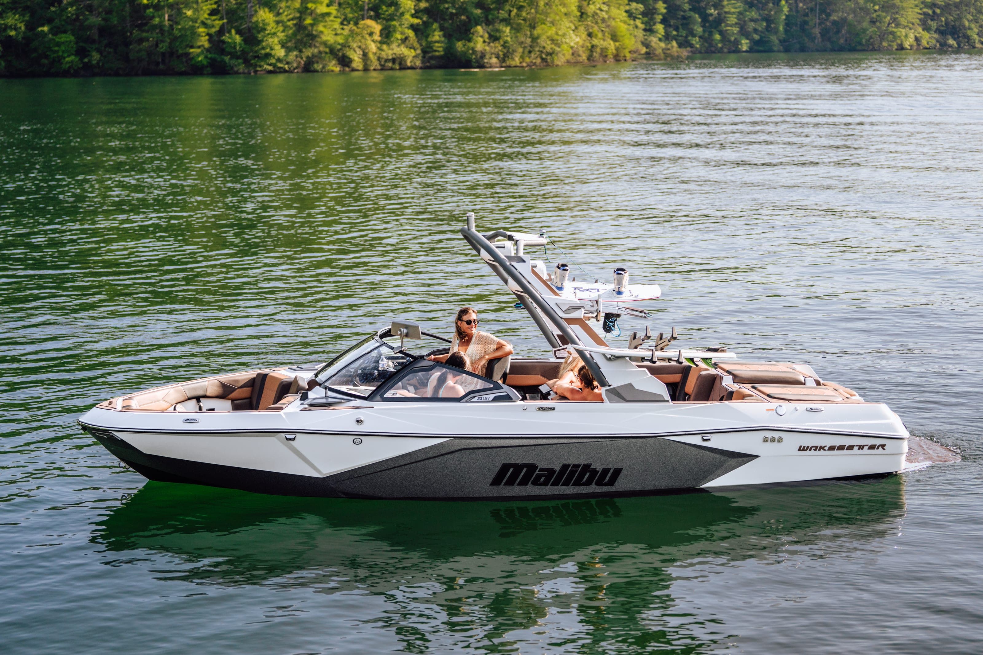 A Malibu 23 LSV at rest, a woman sitting aboard