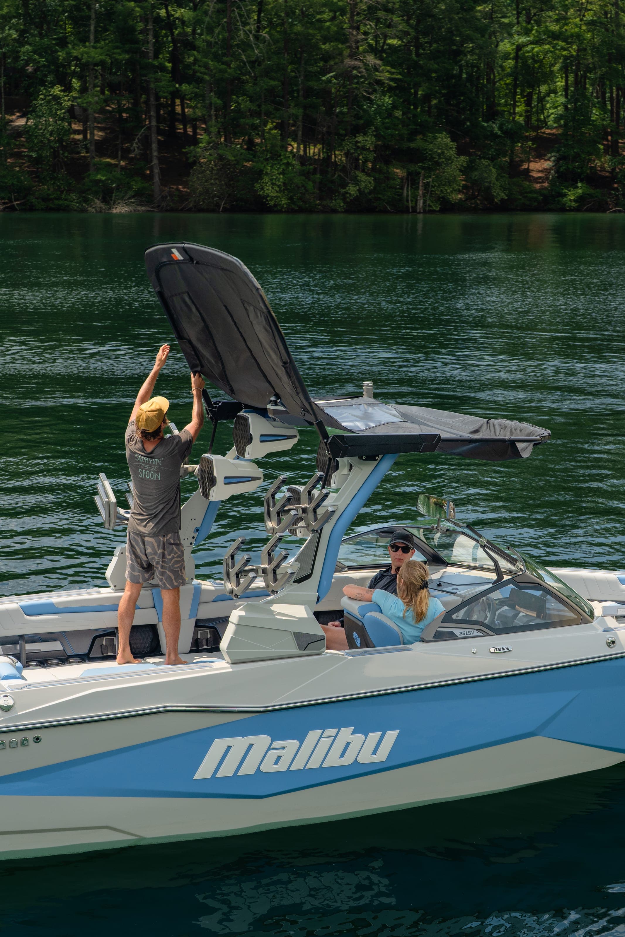 A man raises the tower of a Malibu 25 LSV