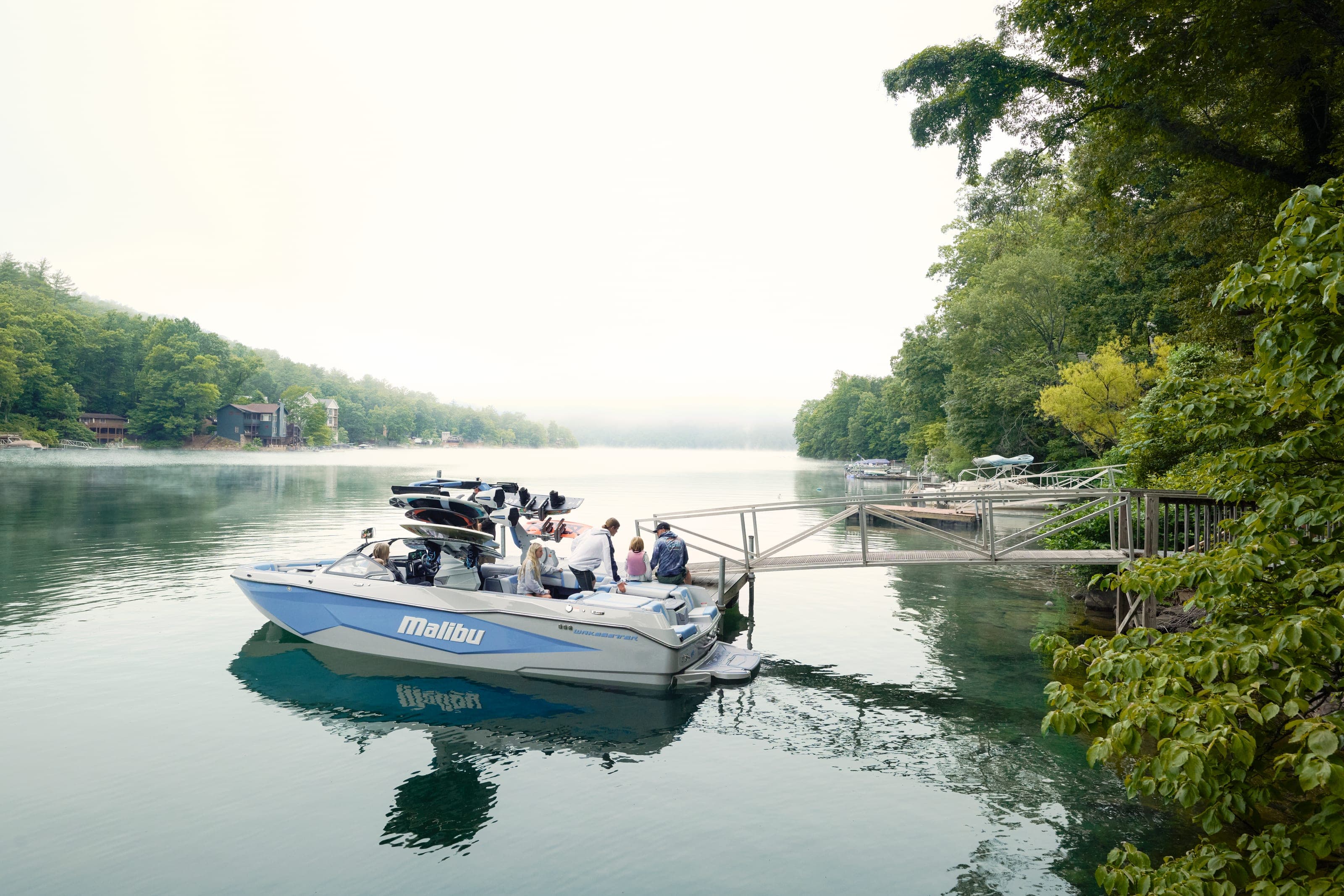 A Malibu 25 LSV at rest near a dock on a still morning