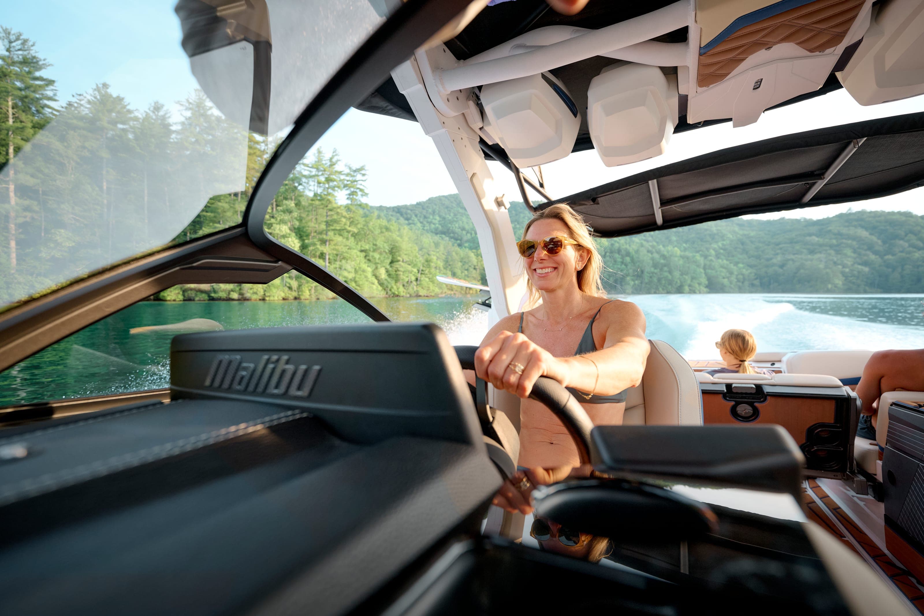 A woman at the helm of a Malibu 26 LSV