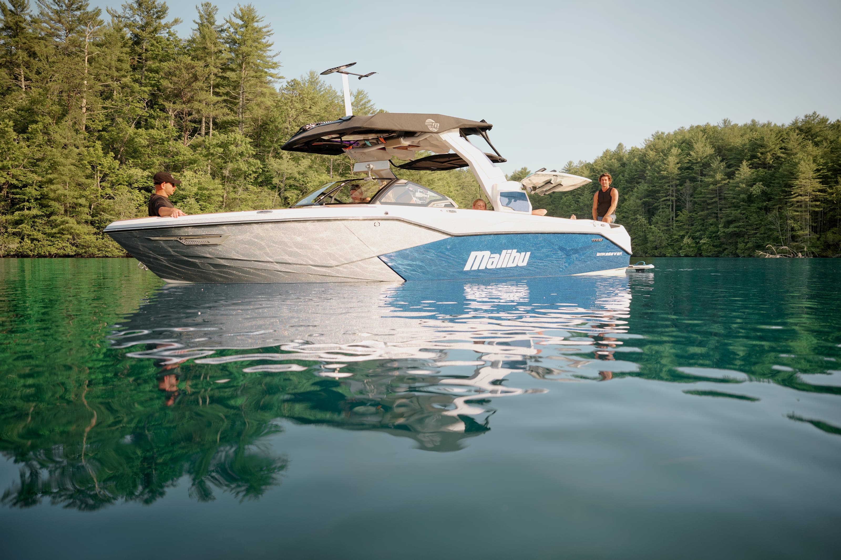 A Malibu 26 LSV at rest, people on the stern
