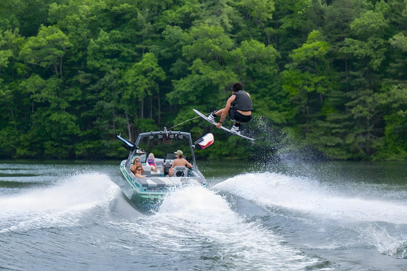 A wakeboarder in the air behind an Axis A200