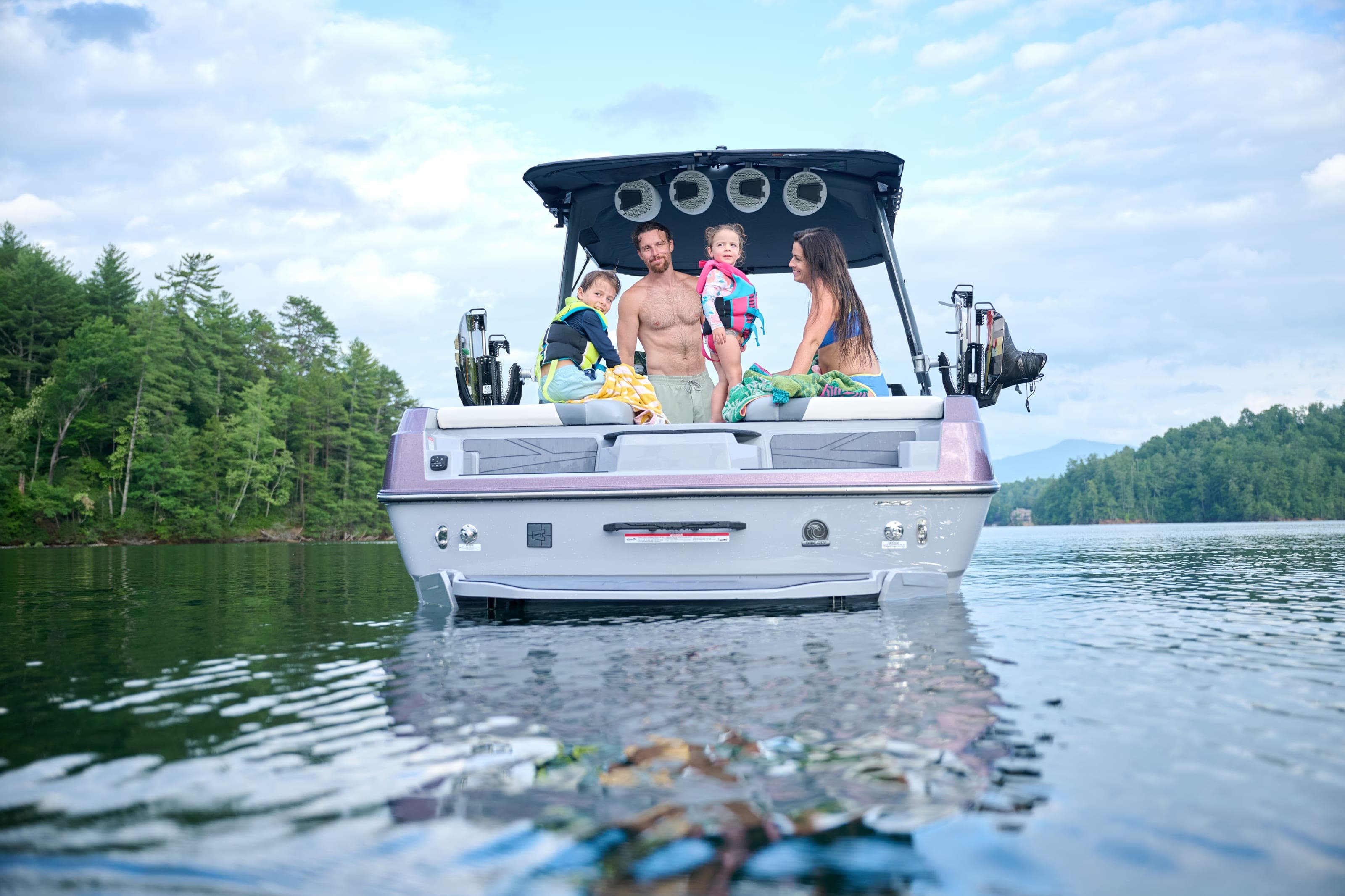People relax at the stern of an Axis T220 at rest