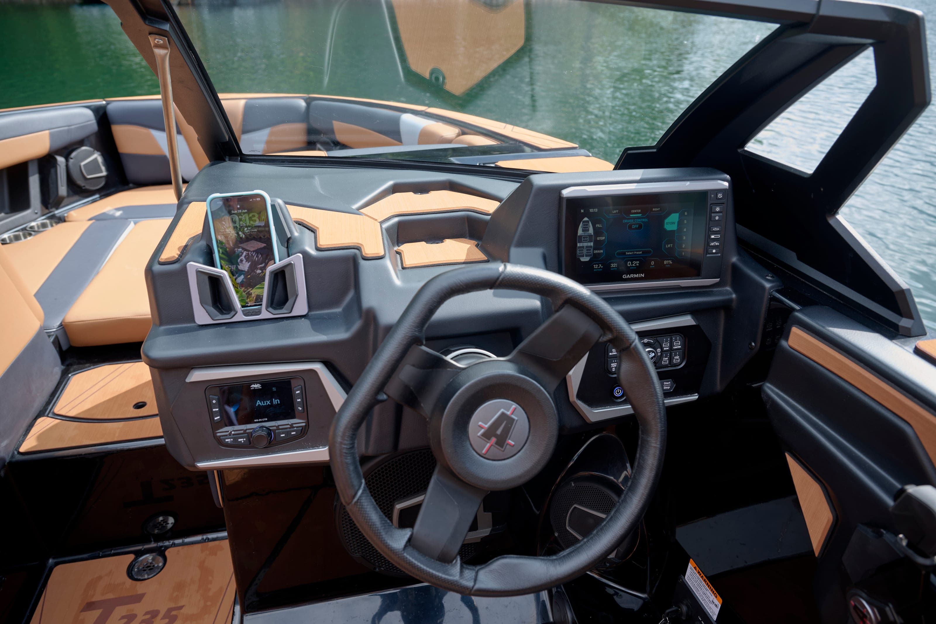 The helm of an Axis T235 with steering wheel and screens