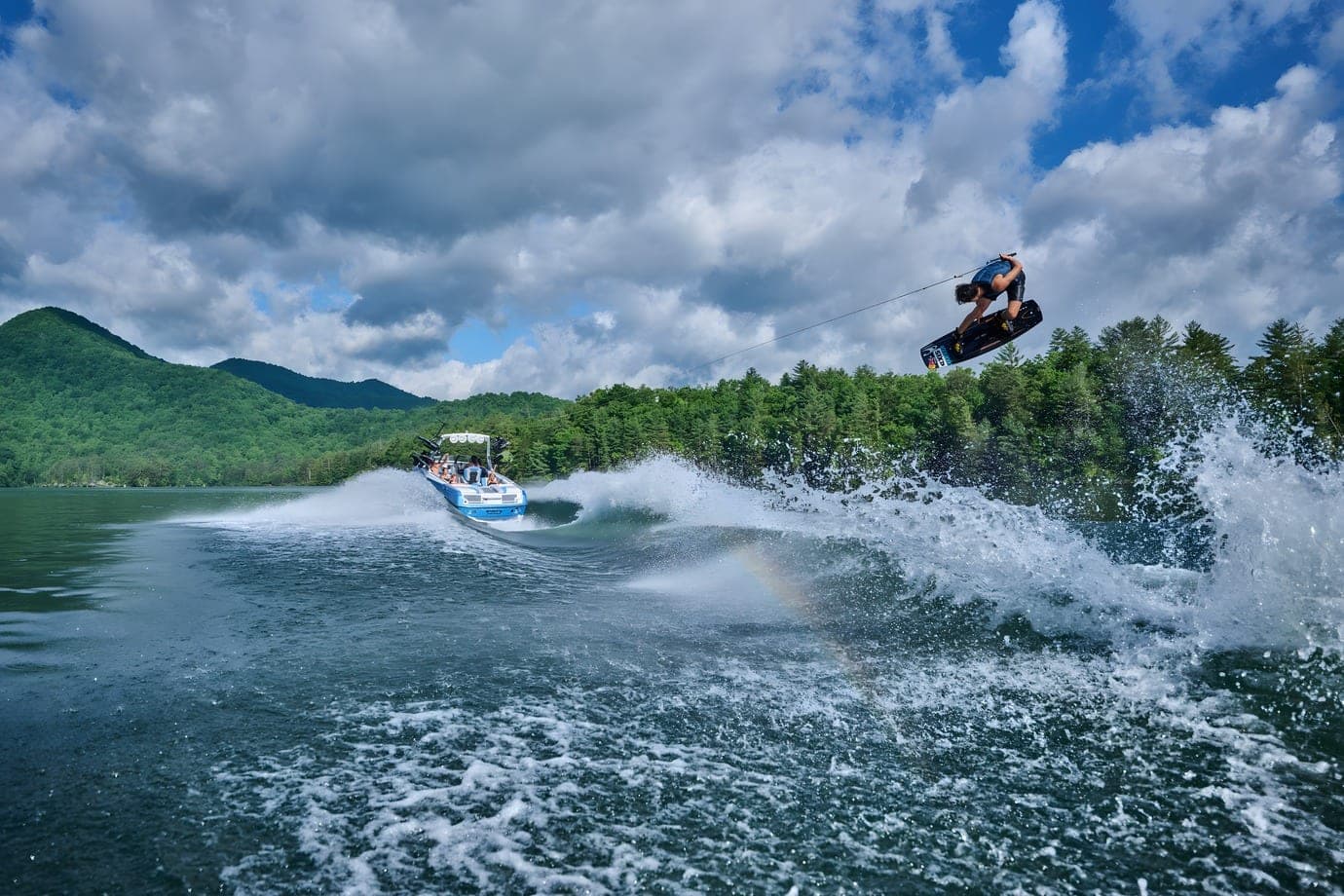 A wakeboarder in the air behind an Axis T250