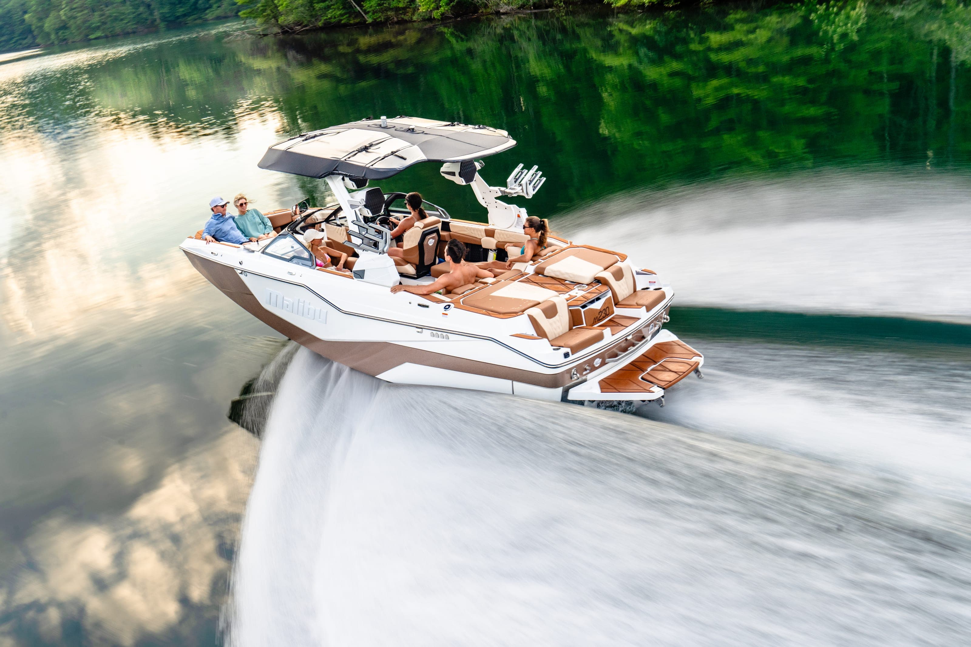 A Malibu M230 at speed seen from above, people aboard