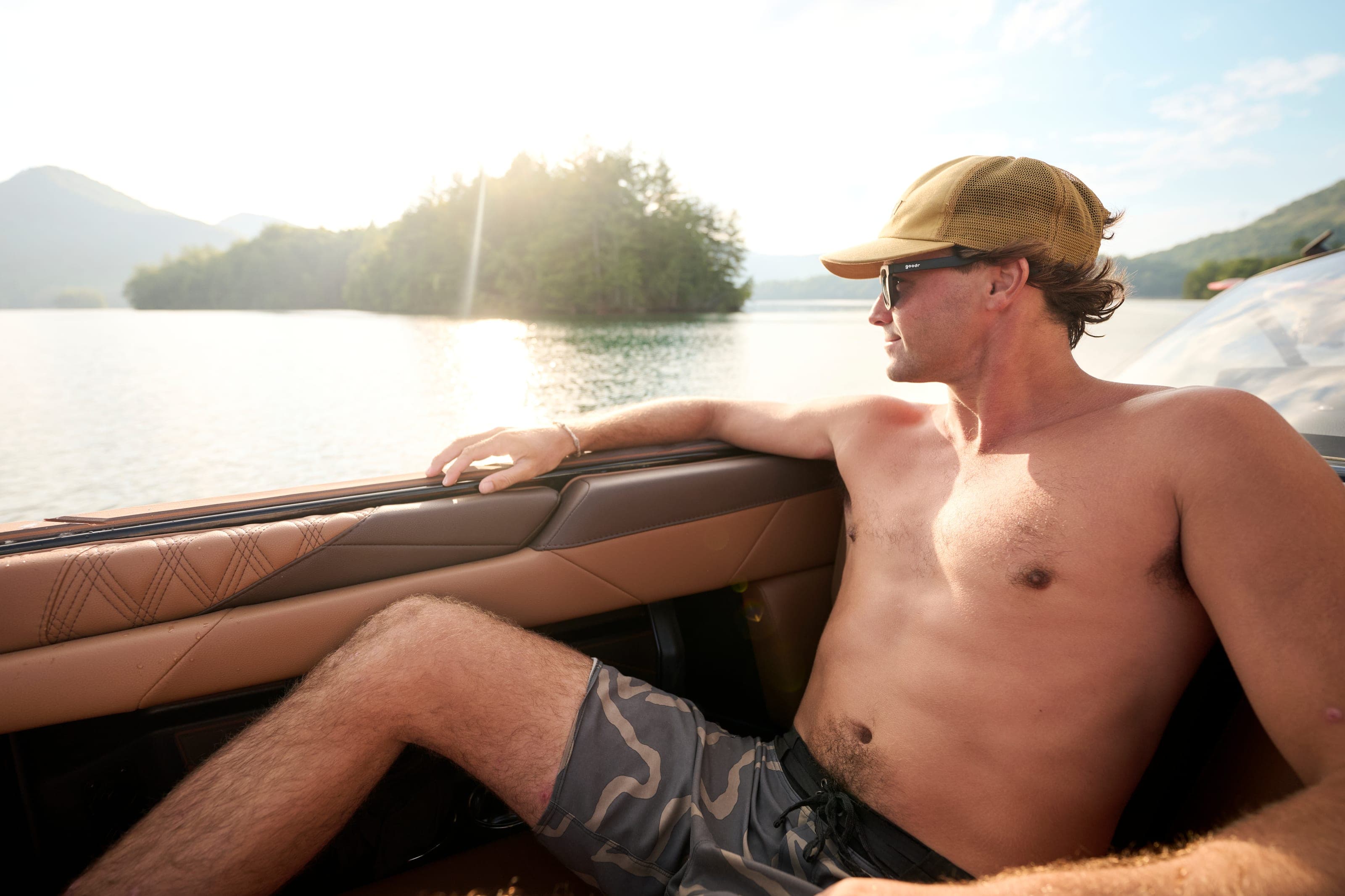 A man relaxes along the side seating of a Malibu M242