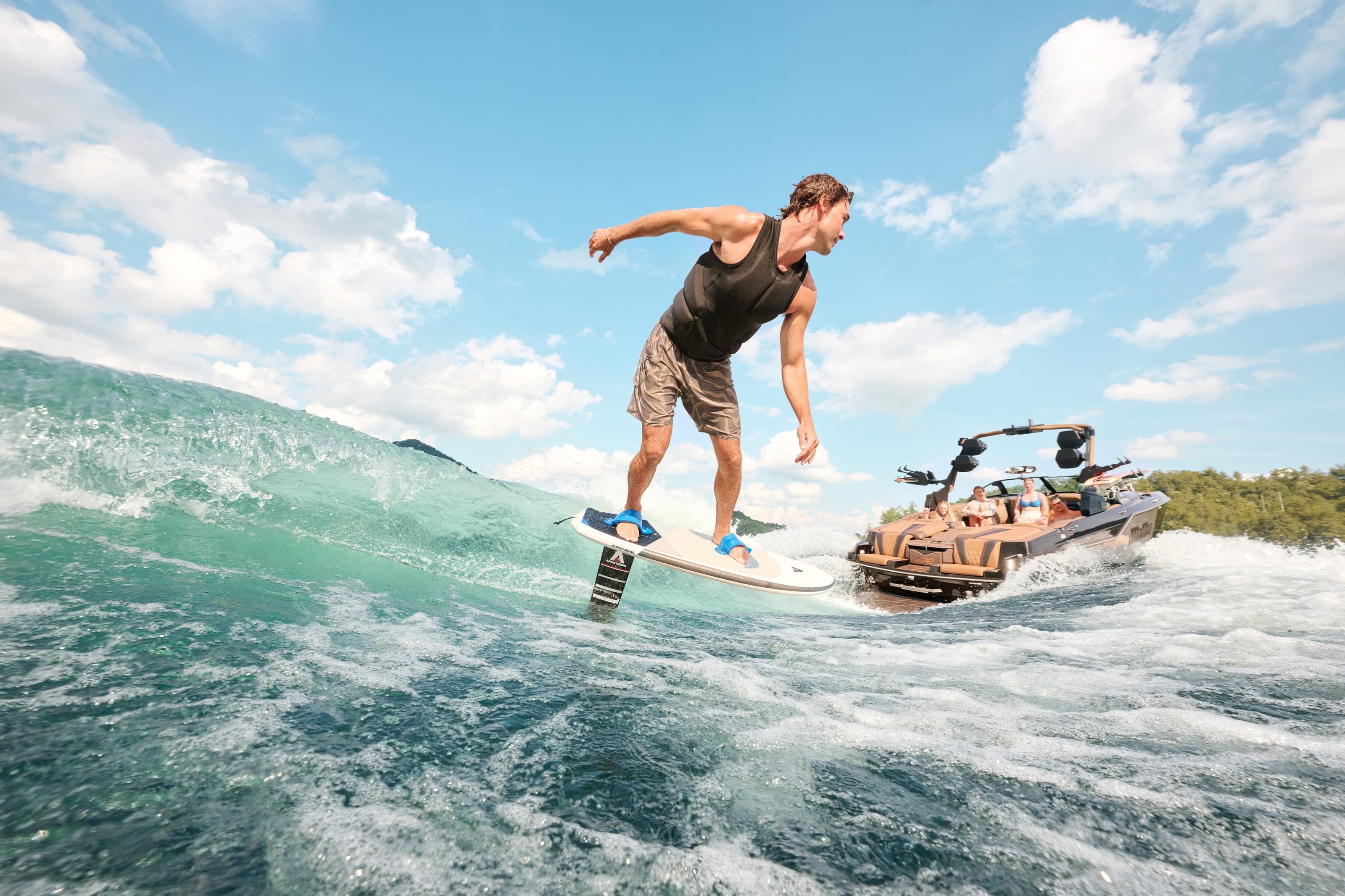 A rider surfs the wave close behind a Malibu M242